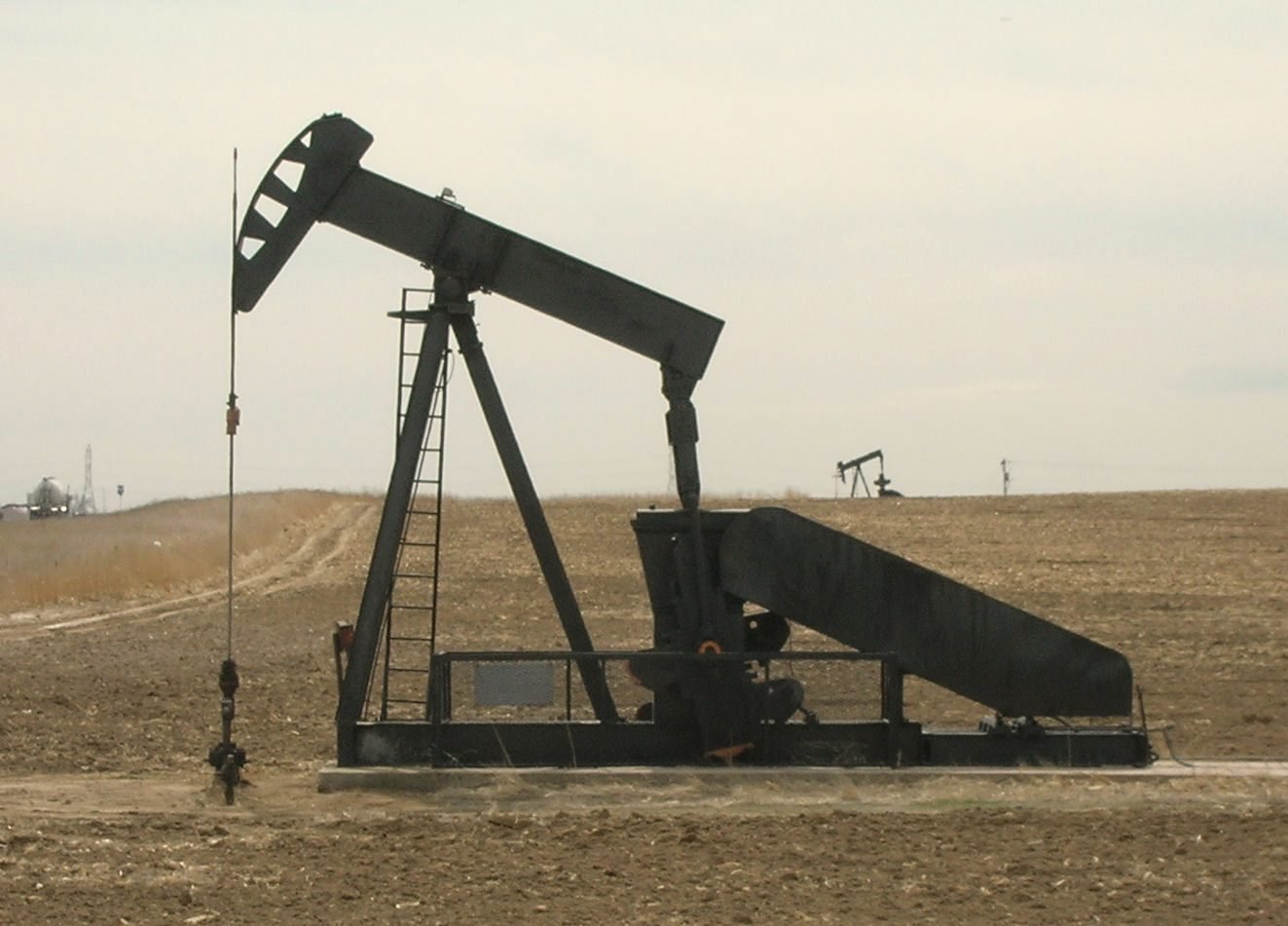 A pump jack turning on an open field