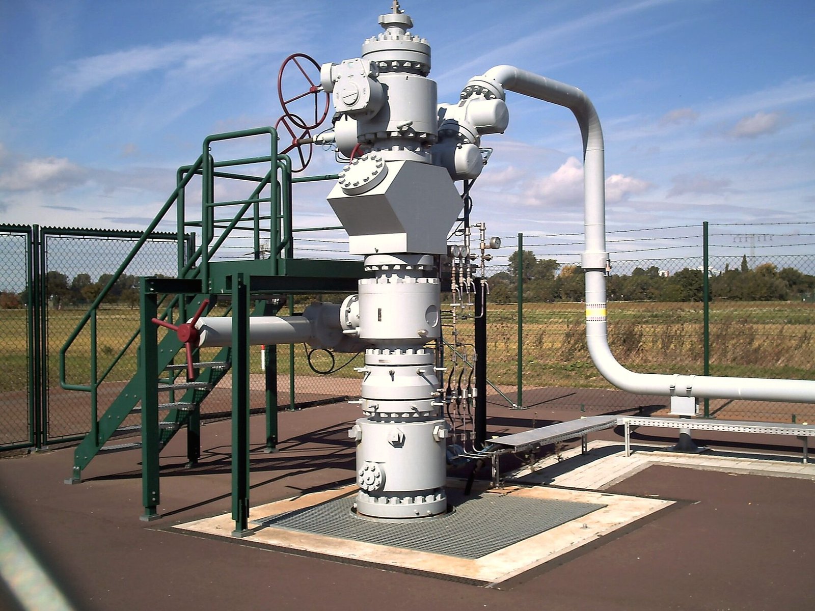 A wellhead and valve tree at a well site